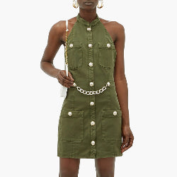 Woman wearing a one piece green halter dress